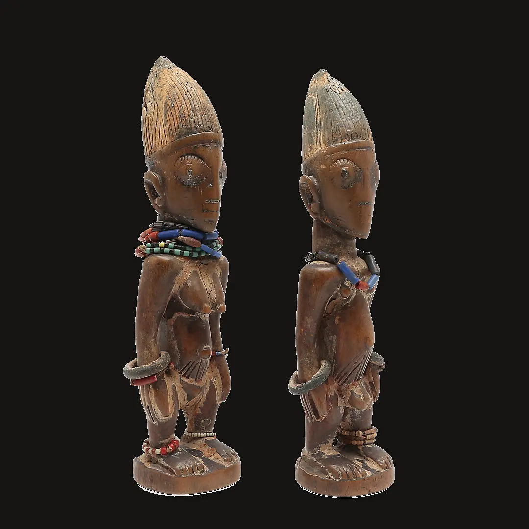 Pair of Ere Ibeji preserving repairs and ritual ornaments