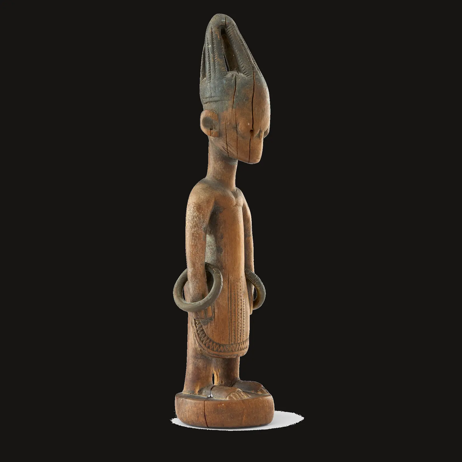 Profile view revealing the structural decisions of an Ere Ibeji carver