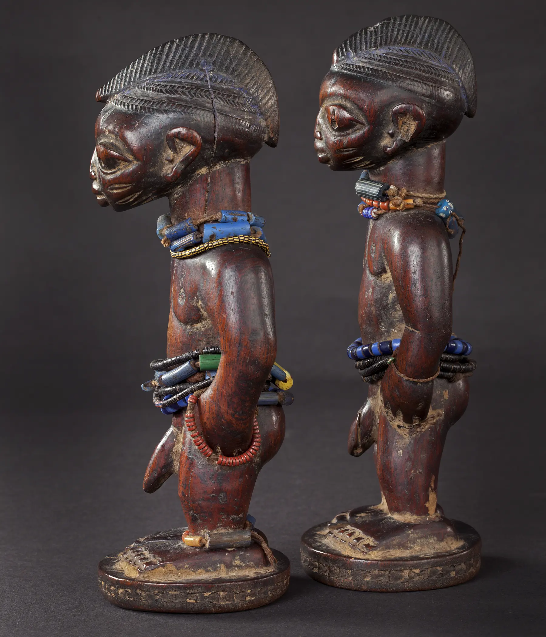 Ritually used pair of Ere Ibeji with beads